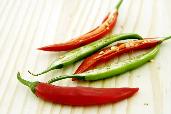 Red and green chillies slices on chopping board