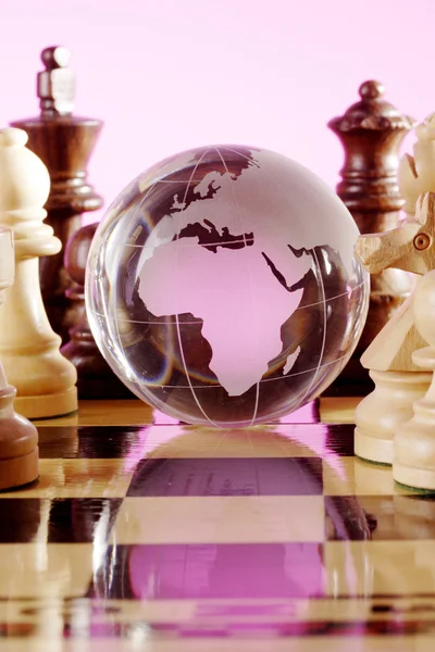 Chess pieces and globe