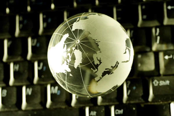 Closeup of Glass globe on computer keyboard