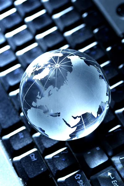 Closeup of Glass globe on computer keyboard