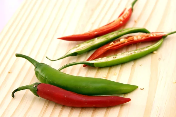 Red and green chillies slices on chopping board