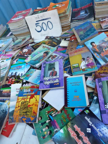 YANGON, BURMA - DECEMBER 23, 2013 - Closer View of Used Books on Sidewalk Bookseller's table