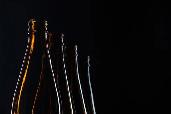 Silhouettes glass bottles for beer on a black background