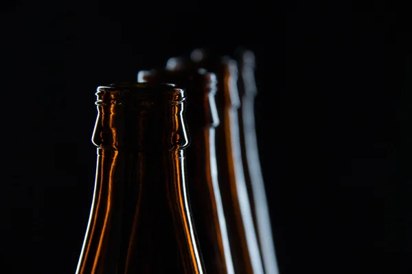 Silhouettes glass bottles for beer on a black background