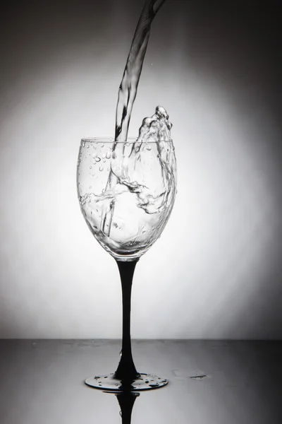 Glass with splashes of clean drinking water