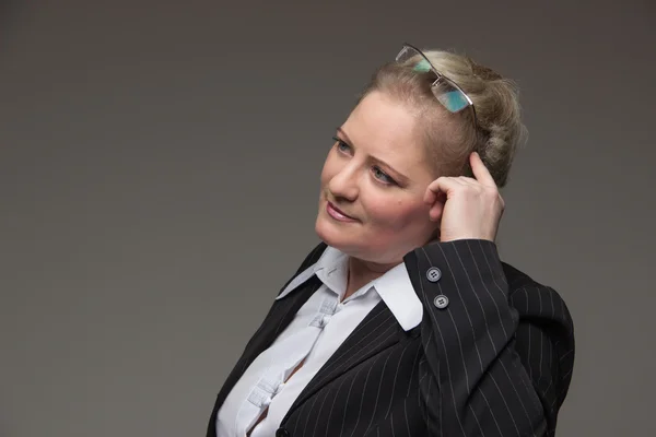 Business fat woman in a suit holding a glasses for vision