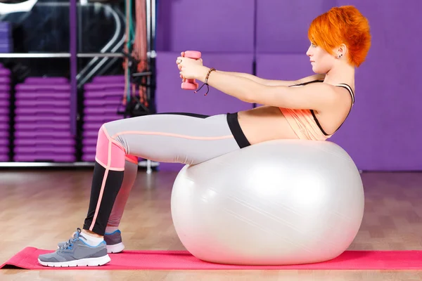 Slim redhead girl doing exercises