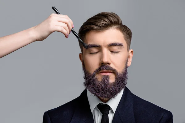Brunette man with violet beard and eyebrows