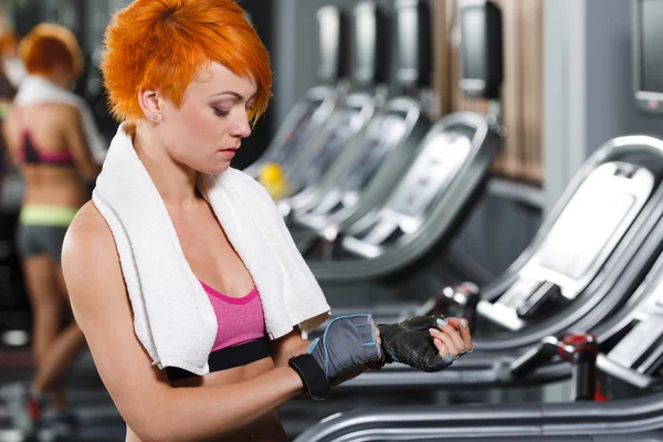 Sport girl with red short hair in gym