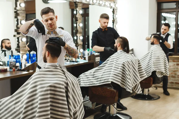 Men at barber shop doing haircuts