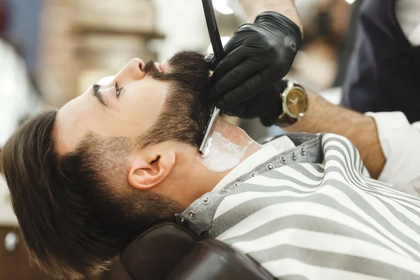 Hands in gloves making beard form