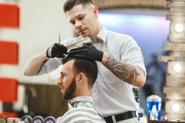 Barber doing haircuts for client