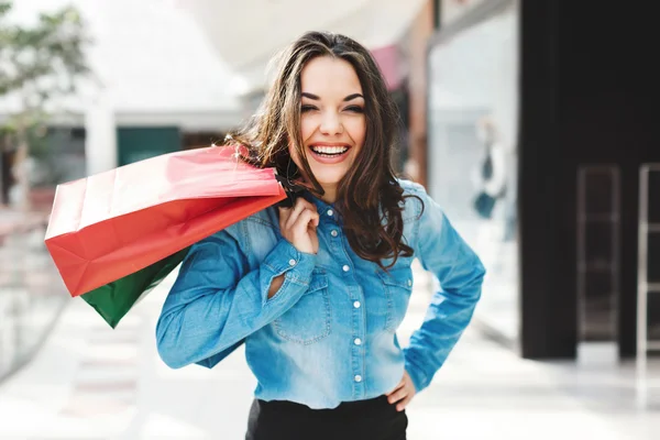 Girl in blue jeans blouse at shopping mall