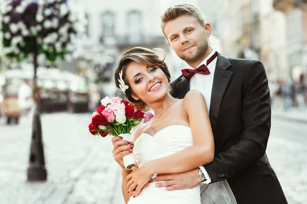 Bride and bridegroom holding bouquet