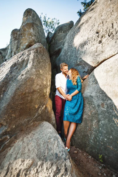 Beloved looking at each other near rocks