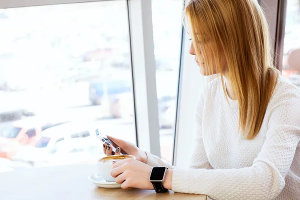 Girl with watches holding mobile phone