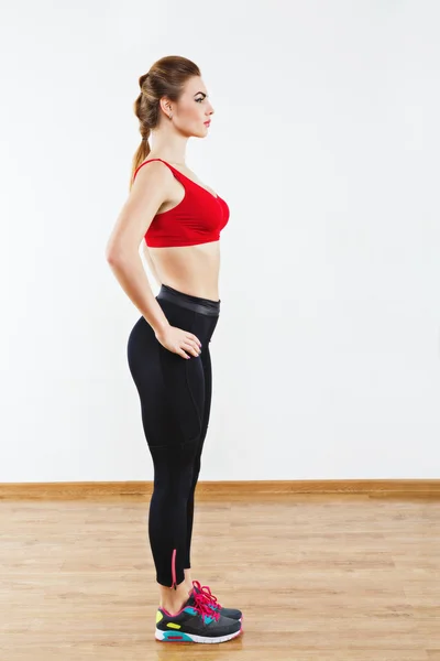 Sportive girl standing in gym