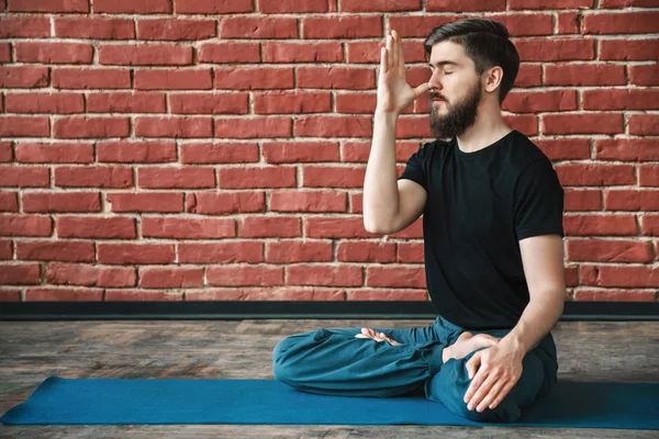 Handsome man doing yoga positions