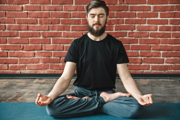 Attractive man doing yoga