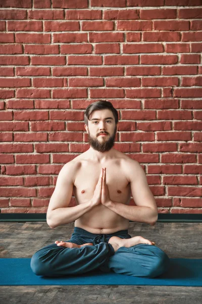 Handsome man doing yoga positions