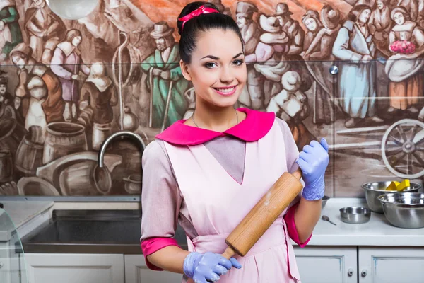 Girl confectioner posing with rolling pin