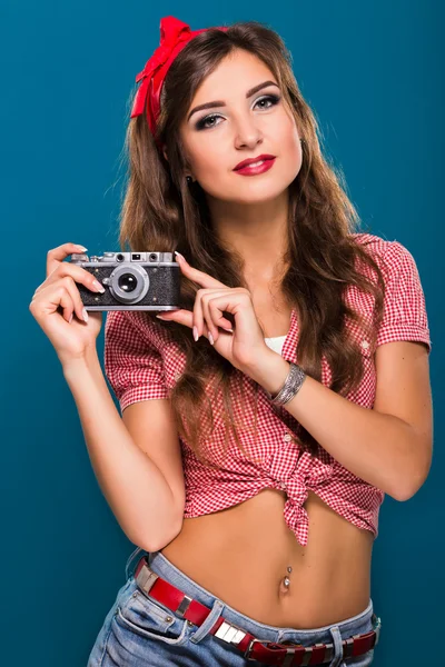Girl holding retro camera