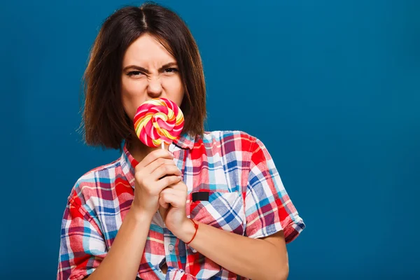 Angry girl posing with colored candy