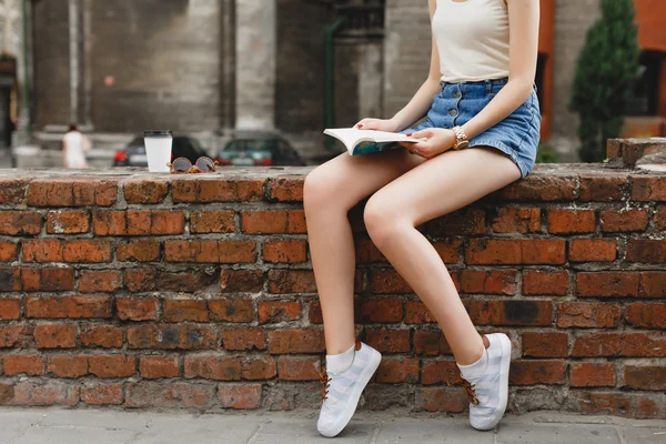 Slim girl reading a book