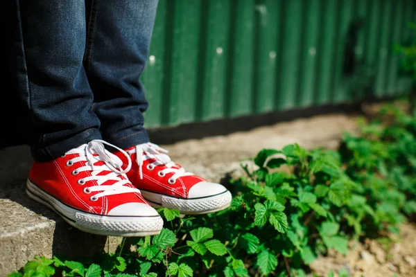 Red shoes on concrete