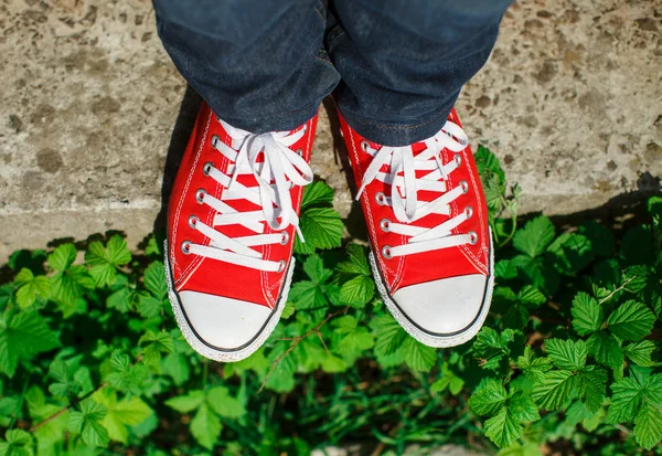 Red shoes on concrete