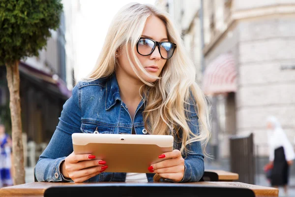 Beautiful blond girl with tablet
