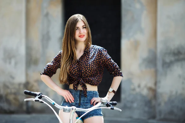 Attractive young girl with bicycle