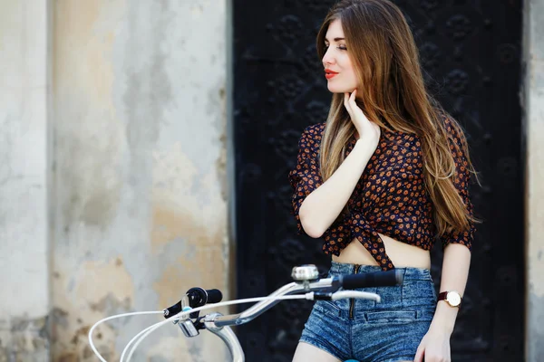 Attractive young girl with bicycle