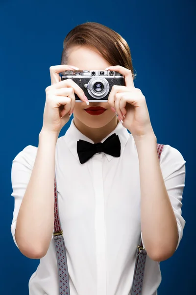 Brunette girl holding retro camera