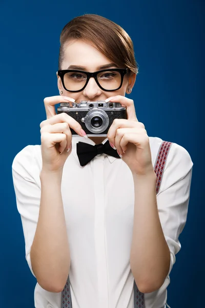 Brunette girl holding retro camera