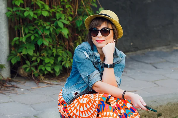 Woman sitting on the curb