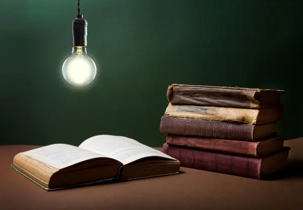 Education concept - open book under the light