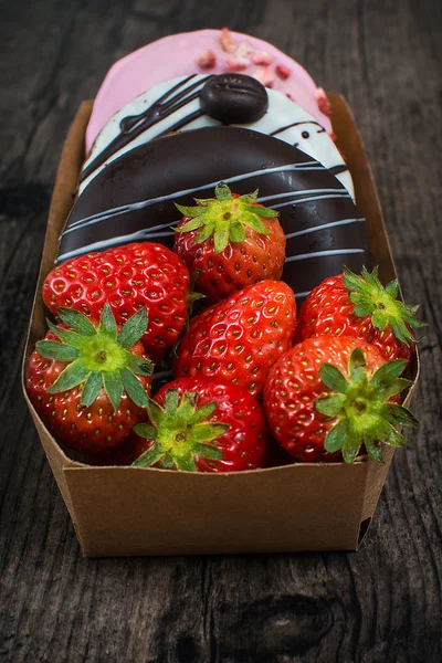 Box of donuts and strawberry