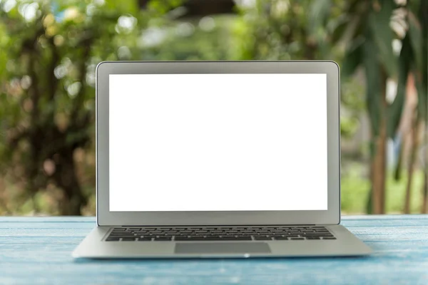 Laptop computer on table in nature background