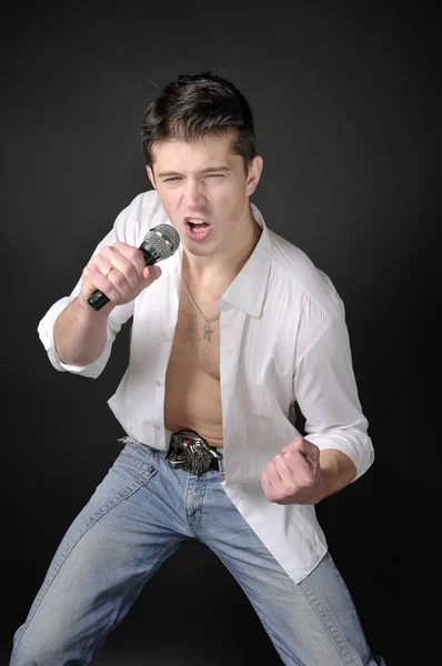 Expressively man singing with microphone