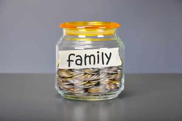 Saving concept of coins in the glass jar for family  purpose