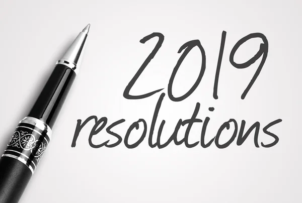 Pen writes 2019 resolutions on paper