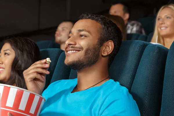 Smiling young man at the movie theatre