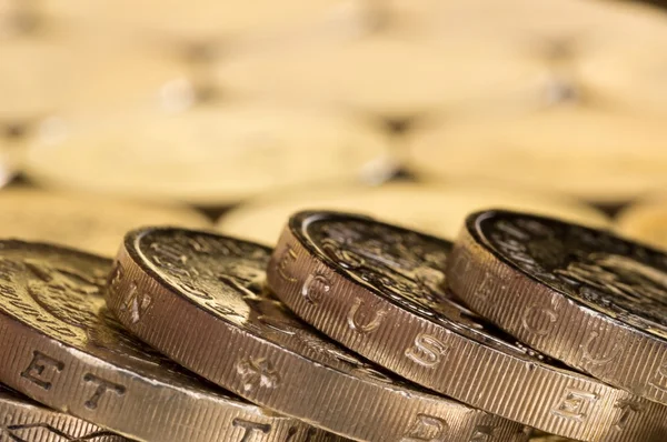 British pound coins on a background of more money.