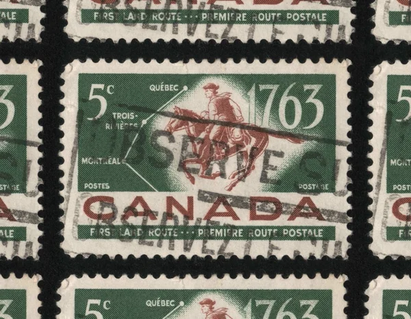 A postage stamp from Canada of a postal worker on a galloping horse.