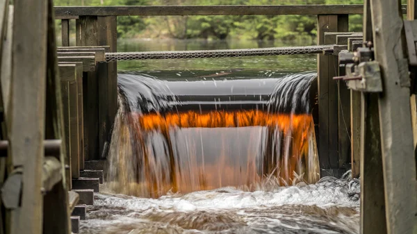 Water from a watermill near an old iron mine is colored due to the iron oxide content