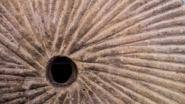 Stone mill wheel with spiral pattern grinder