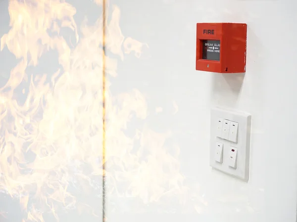 Fire alarm on white wall and frame of fire filter