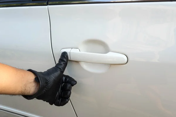 Push tumb on handle of car door