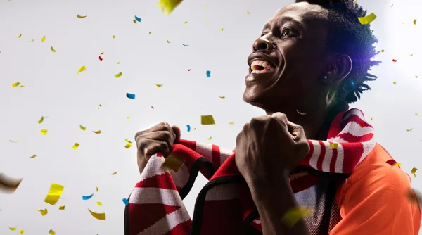 Black Soccer fan in action emotions confetti